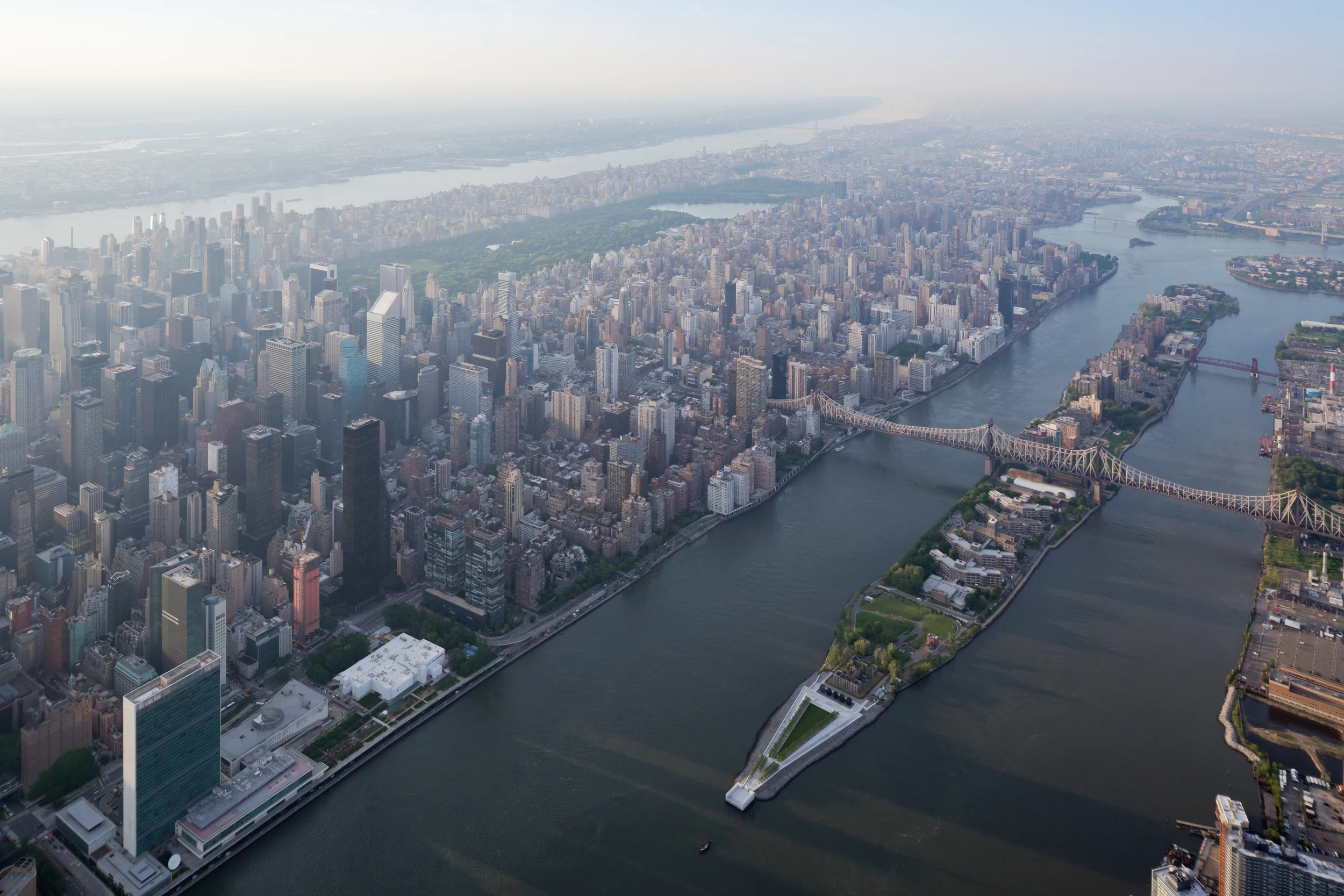 Aerial view looking north over Roosevelt Island's southern tip and midtown Manhattan, with the ruin marked